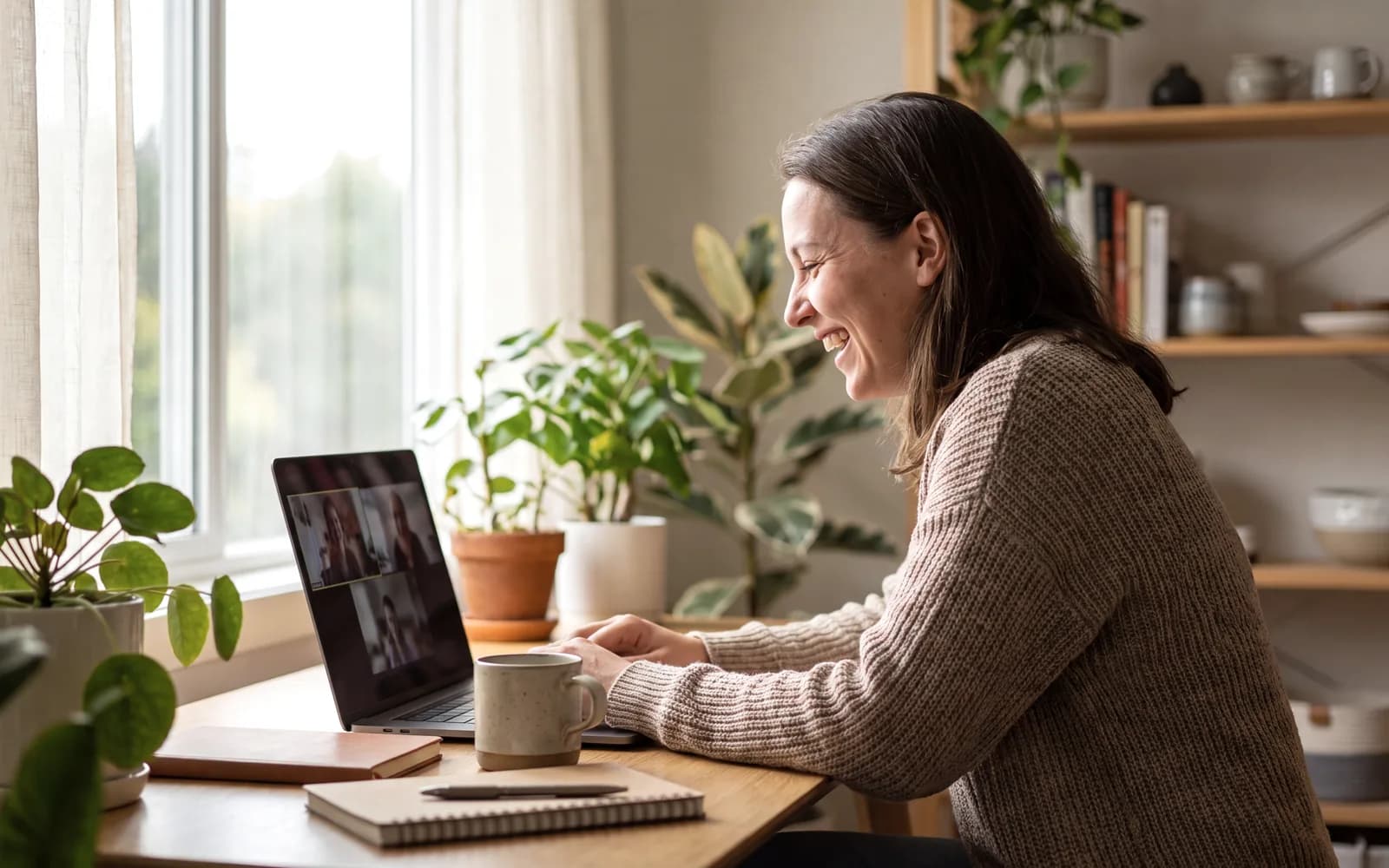 A woman on a video call at her home office desk